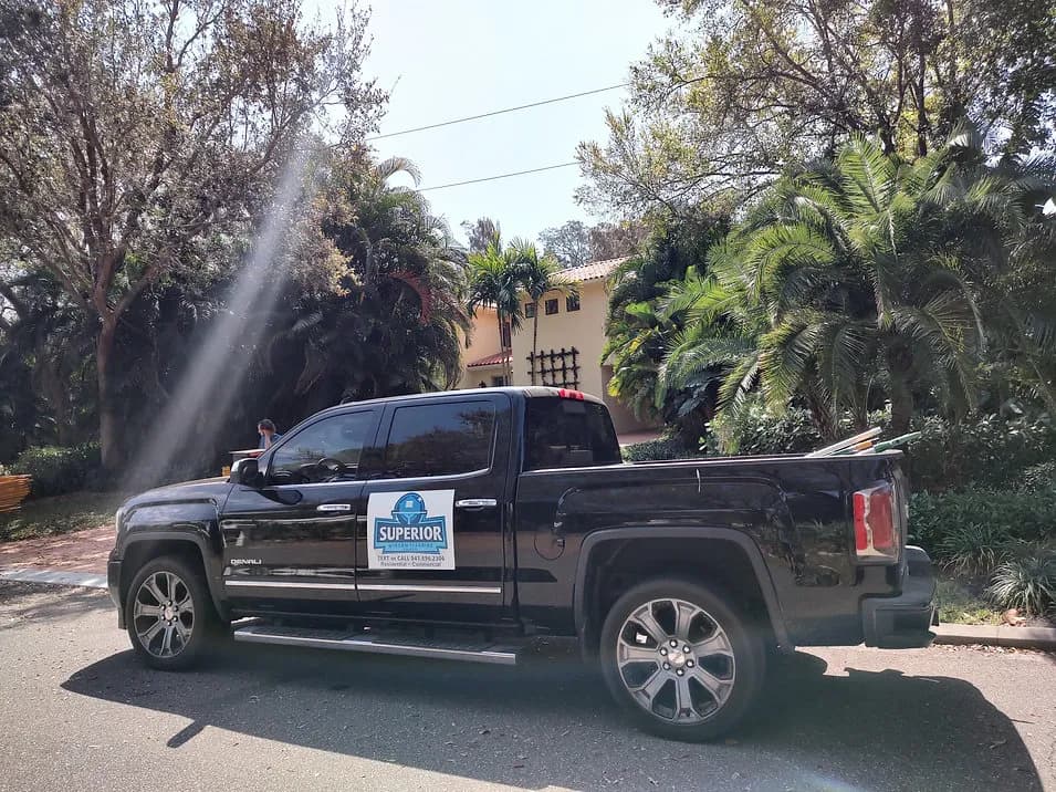 Superior Window Cleaning truck parked on a tree-lined Sarasota street